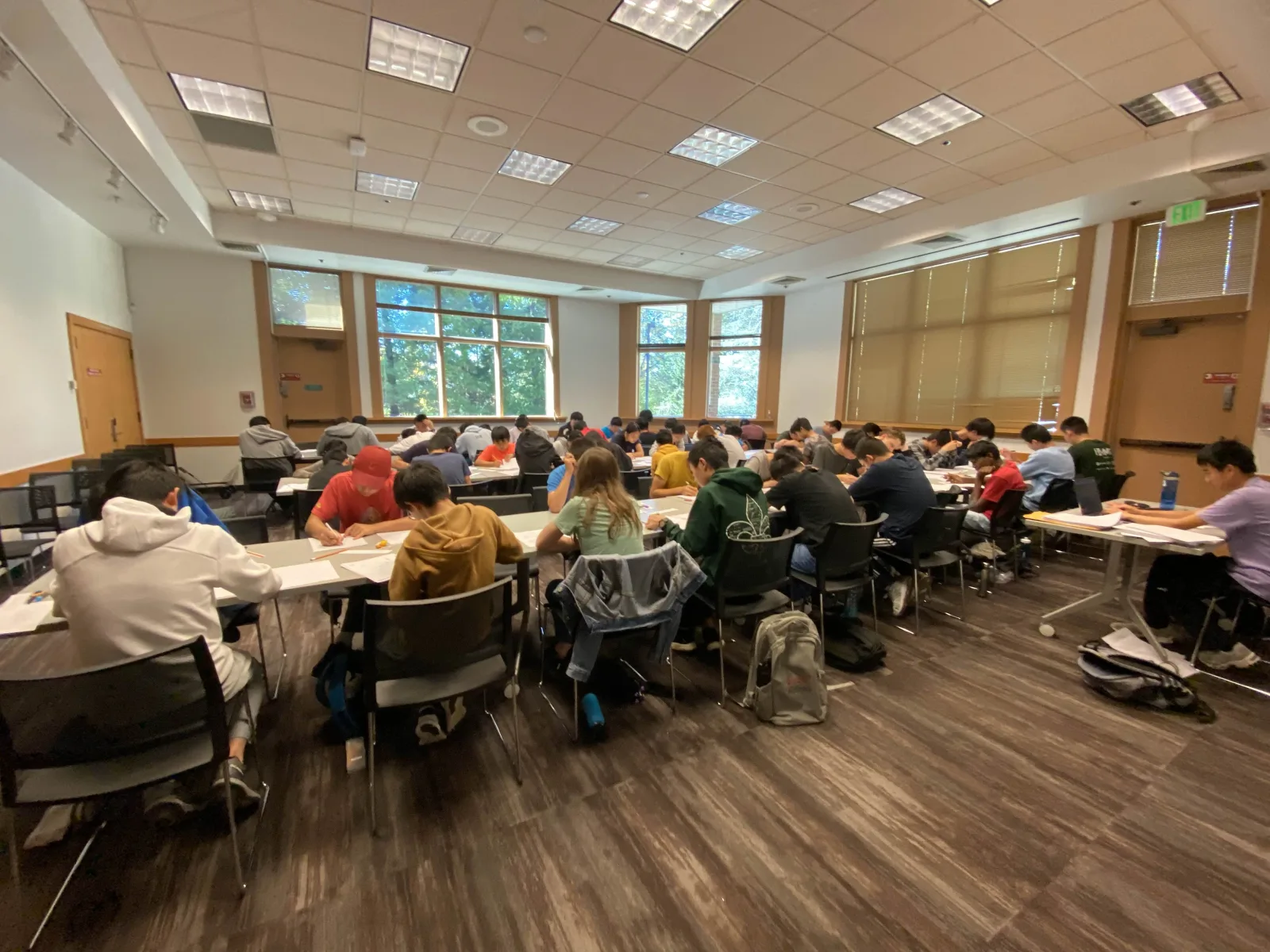 Students working on math problems at a SIMC event